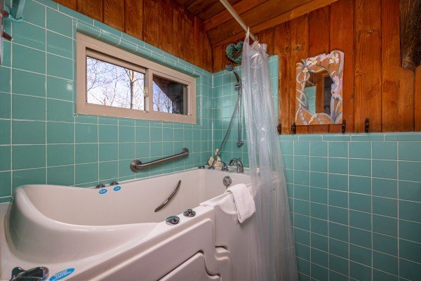 Bathtub and shower at Ever After, a 1 bedroom cabin rental located in Gatlinburg