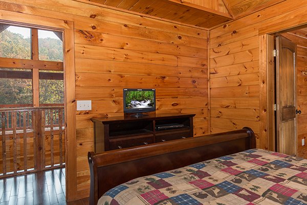 Dresser and TV in the queen bedroom at Rocky Top Lodge, a 3 bedroom cabin rental located in Pigeon Forge
