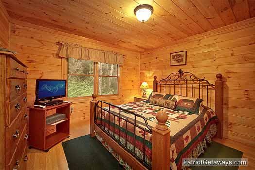 Main floor bedroom with queen bed at Bear Creek, a 4-bedroom cabin rental located in Pigeon Forge