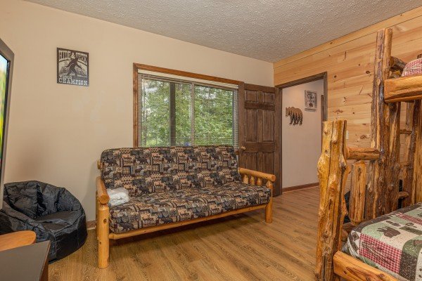 Bunk room with a futon at Cubs' Crib, a 3 bedroom cabin rental located in Gatlinburg