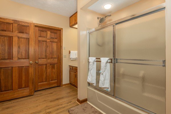 Bathroom with a tub and shower at Cubs' Crib, a 3 bedroom cabin rental located in Gatlinburg