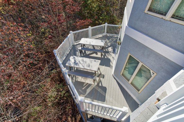 Looking down at the deck picnic tables at Chalet Mignon, an 8-bedroom cabin rental located in Gatlinburg