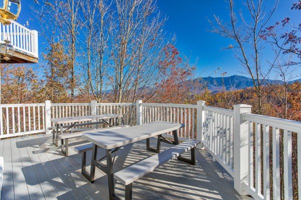 Picnic tables on the deck at Chalet Mignon, an 8-bedroom cabin rental located in Gatlinburg
