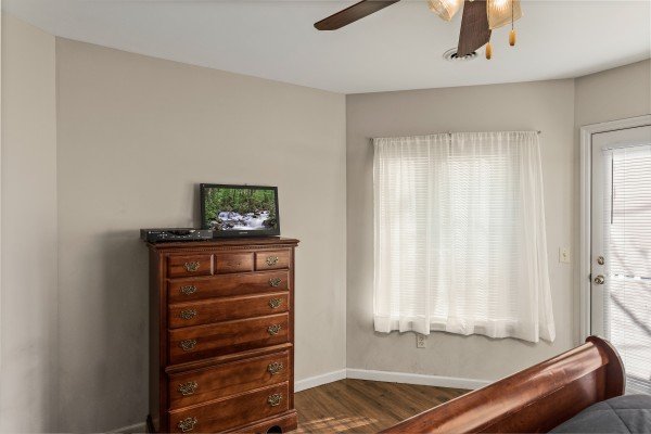Dresser and TV in a bedroom at Chalet Mignon, an 8-bedroom cabin rental located in Gatlinburg