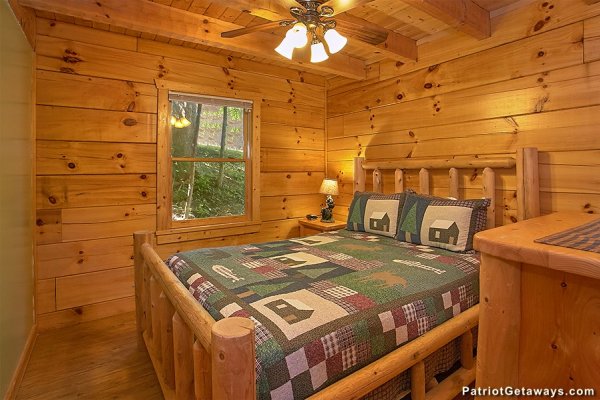Queen log bed in a bedroom at Picture Perfect Hideaway, a 2 bedroom cabin rental located in Pigeon Forge