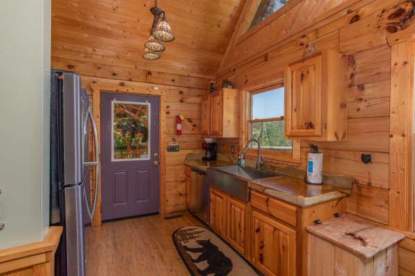 Kitchen with a farmhouse sink and window at Picture Perfect Hideaway, a 2 bedroom cabin rental located in Pigeon Forge