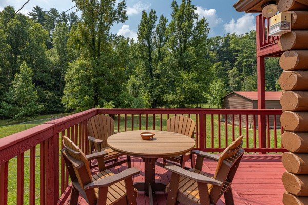 Dining table on the deck  at 1 Crazy Cub, a 4 bedroom cabin rental located in Pigeon Forge