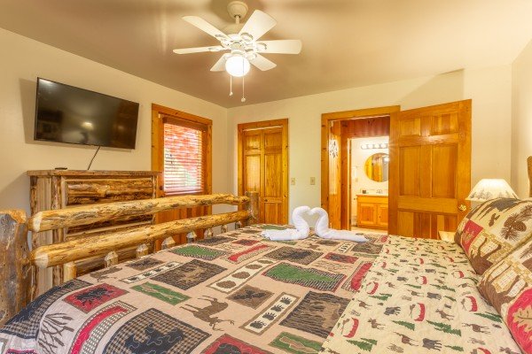Loft bedroom with tv and bathroom at 1 Crazy Cub, a 4 bedroom cabin rental located in Pigeon Forge