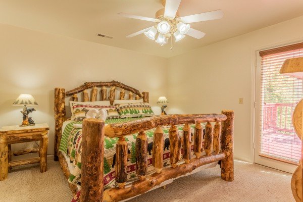 Log bed next to patio door at 1 Crazy Cub, a 4 bedroom cabin rental located in Pigeon Forge