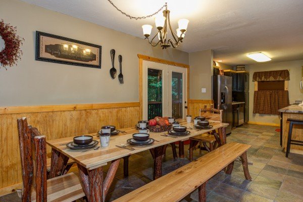 Dining table for 8 in cabin 1 at The Settlement, a 10 bedroom cabin rental located in Pigeon Forge