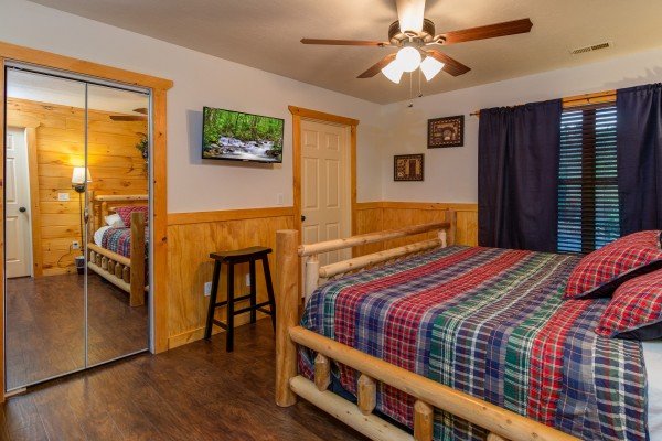 Stool, closet, and TV in a bedroom at The Settlement, a 10 bedroom cabin rental located in Pigeon Forge