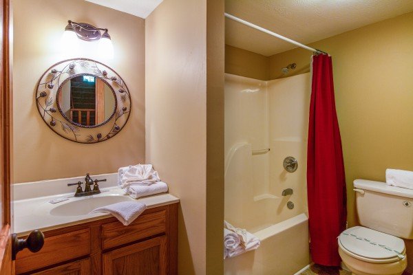 Bathroom with a tub and shower at The Settlement, a 10 bedroom cabin rental located in Pigeon Forge