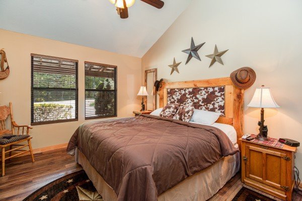 King bed with night stands and lamps in cabin 2 at The Settlement, a 10 bedroom cabin rental located in Pigeon Forge