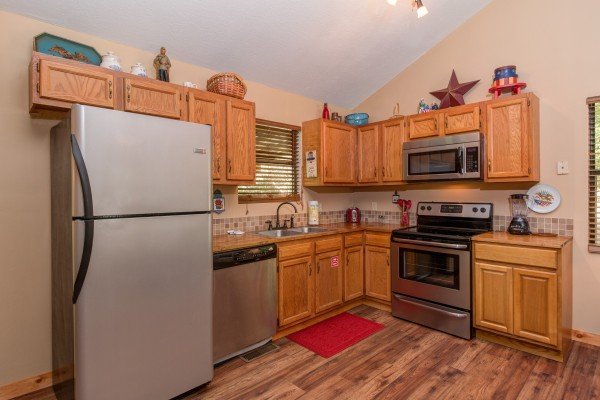 Kitchen with stainless appliances in cabin 2 at The Settlement, a 10 bedroom cabin rental located in Pigeon Forge