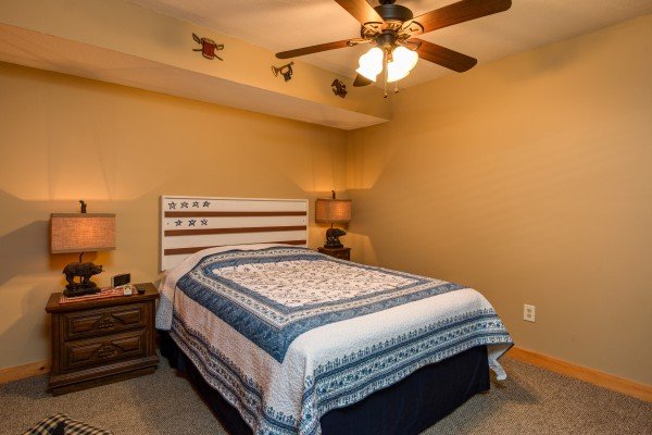 Bedroom with nightstands and lamps in cabin 2 at The Settlement, a 10 bedroom cabin rental located in Pigeon Forge