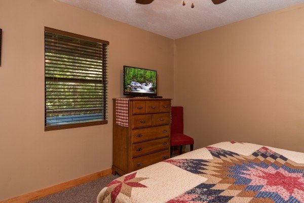 Dresser and TV in the bedroom at cabin 2 at The Settlement, a 10 bedroom cabin rental located in Pigeon Forge