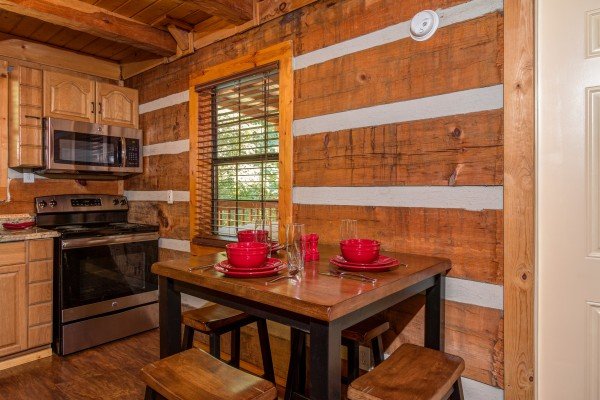 Dining table for three in cabin 3 at The Settlement, a 10 bedroom cabin rental located in Pigeon Forge