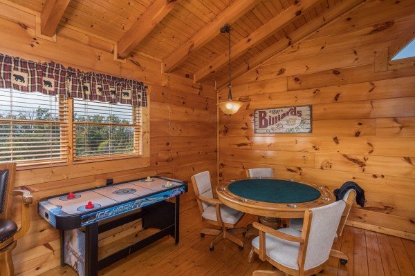 Air hockey & card table in the game loft at Graceland, a 4-bedroom cabin rental located in Pigeon Forge