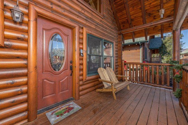 Front porch with Adirondack bench at Loving Every Minute, a 5 bedroom cabin rental located in Pigeon Forge