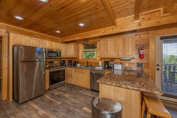 Kitchen area and door leading to deck  at Loving Every Minute, a 5 bedroom cabin rental located in Pigeon Forge