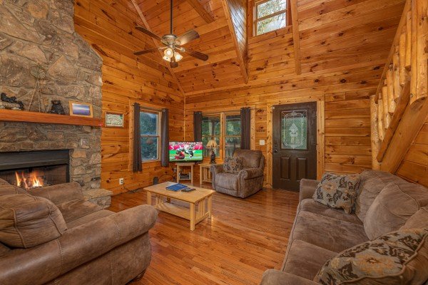 Living room with fireplace and TV at Family Getaway, a 4 bedroom cabin rental located in Pigeon Forge