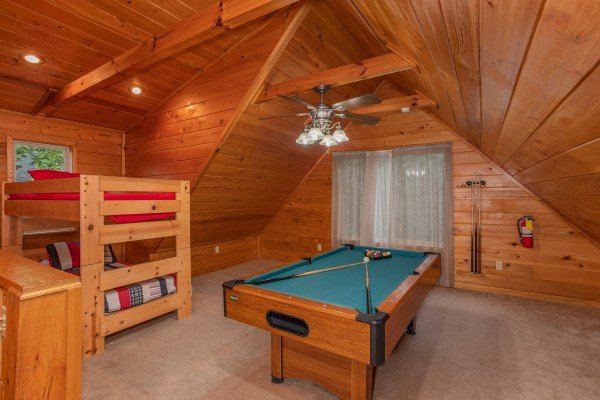 Bunk bed and pool table in the loft game room at Eastern Retreat, a 1-bedroom cabin rental located in Gatlinburg