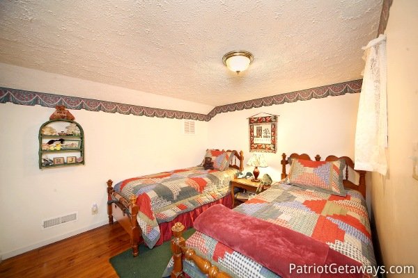 Two twin beds in bedroom at Dolly's Adorable River Cottage, a 3-bedroom cabin rental located in Pigeon Forge