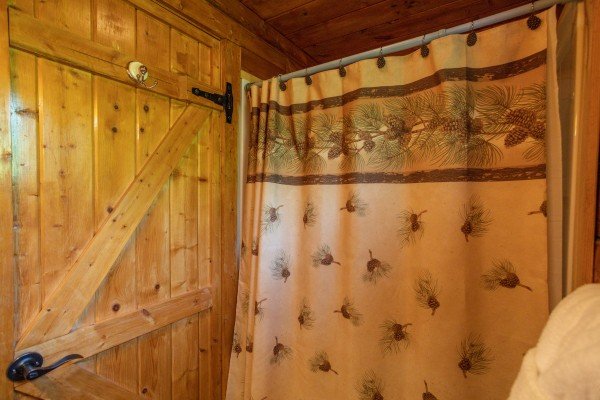 Bathroom with tub and shower at Mountain Breeze, a 1 bedroom cabin rental located in Pigeon Forge