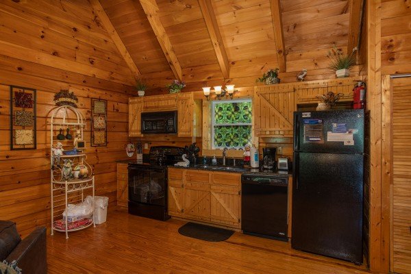 Kitchen with black appliances at Mountain Breeze, a 1 bedroom cabin rental located in Pigeon Forge