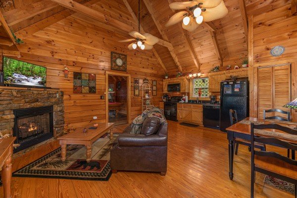 Living room with fireplace and TV at Mountain Breeze, a 1 bedroom cabin rental located in Pigeon Forge