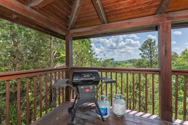 Grill on a covered deck at Top of the Way, a 2 bedroom cabin rental located in Pigeon Forge