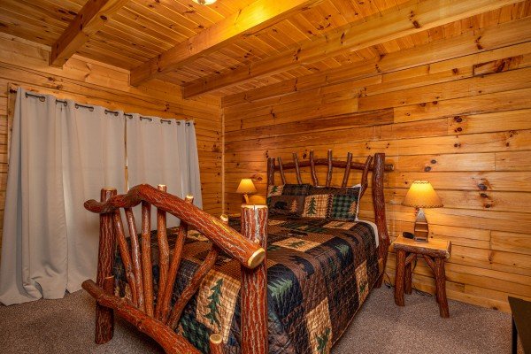Log bed at Top of the Way, a 2 bedroom cabin rental located in Pigeon Forge