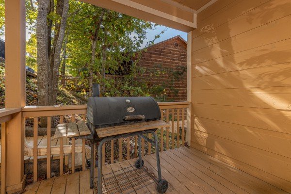 Grill on the covered deck at Into the Woods, a 3 bedroom cabin rental located in Pigeon Forge