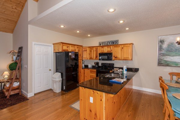 Kitchen with black appliances at Into the Woods, a 3 bedroom cabin rental located in Pigeon Forge