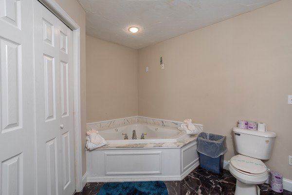 Corner jacuzzi tub in a bathroom at Into the Woods, a 3 bedroom cabin rental located in Pigeon Forge