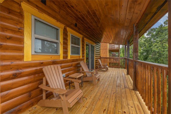 Adirondack chairs on a covered deck at Alpine Adventure, a 4 bedroom cabin rental located in Pigeon Forge