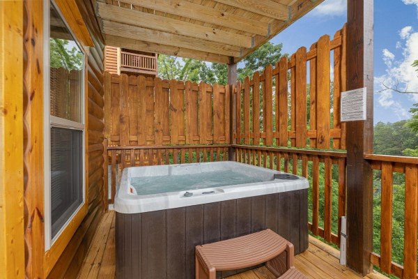 Hot tub with privacy fence on a covered deck at Alpine Adventure, a 4 bedroom cabin rental located in Pigeon Forge