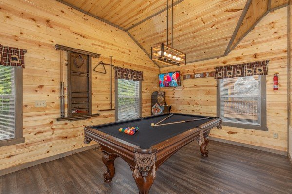 Black felt pool table in the loft at Alpine Adventure, a 4 bedroom cabin rental located in Pigeon Forge