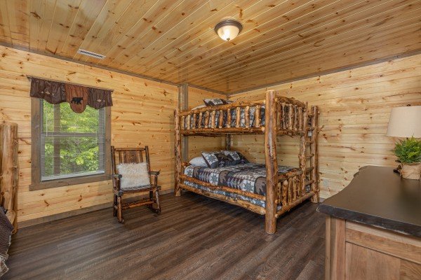 Bunk beds, rocking chair, and dresser in a bedroom at Alpine Adventure, a 4 bedroom cabin rental located in Pigeon Forge