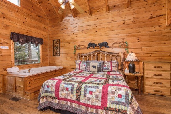 Bedroom with a jacuzzi tub at 5 Star Celebration, a 1 bedroom cabin rental located in Pigeon Forge