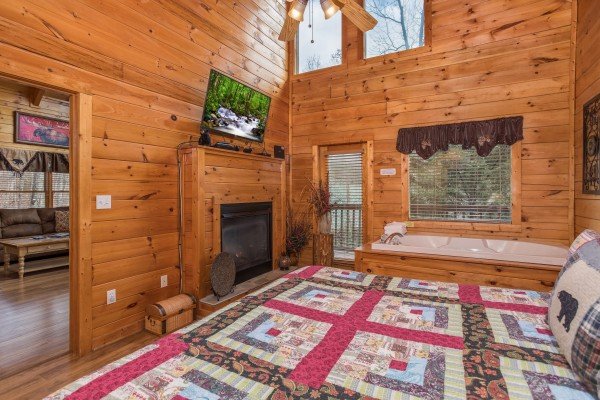 Fireplace and TV in a bedroom at 5 Star Celebration, a 1 bedroom cabin rental located in Pigeon Forge