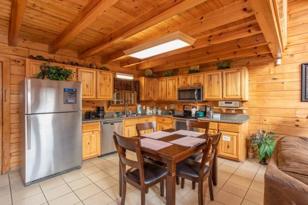 Kitchen with dining table for four at 5 Star Celebration, a 1 bedroom cabin rental located in Pigeon Forge