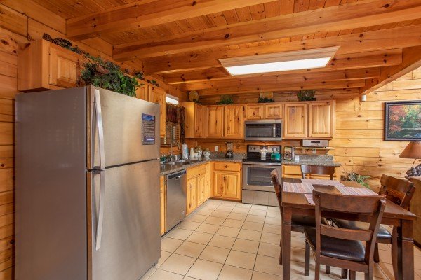 Dining and kitchen space at 5 Star Celebration, a 1 bedroom cabin rental located in Pigeon Forge