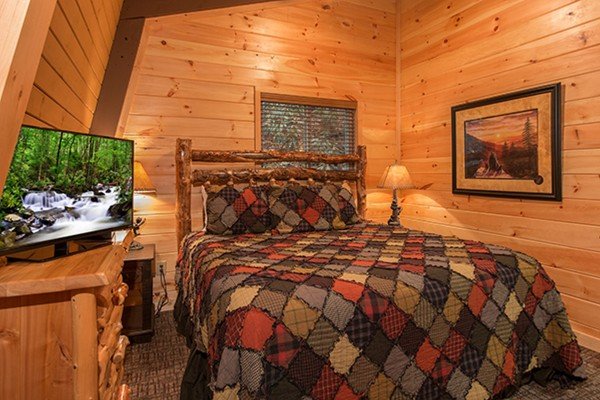 king bed on first floor at Without A Paddle, a 3 bedroom cabin rental located in Gatlinburg