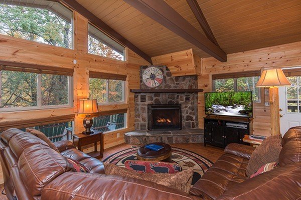 Living room with fireplace and TV at Without A Paddle, a 3 bedroom cabin rental located in Gatlinburg