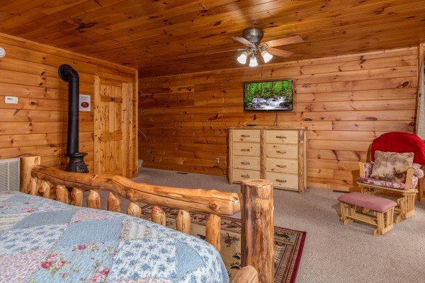 Dresser, TV, and rocking chair in a bedroom at Hummingbird's Views, a 1 bedroom cabin rental located in Pigeon Forge