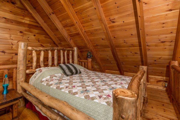 Log bed in the loft at Hummingbird's Views, a 1 bedroom cabin rental located in Pigeon Forge