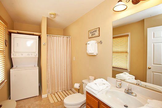 En suite bath with washer and dryer at Heaven Sent, a 2-bedroom cabin rental located in Pigeon Forge