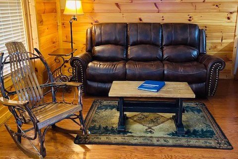 Sofa and rocking chair in a living room at Heaven Sent, a 2-bedroom cabin rental located in Pigeon Forge