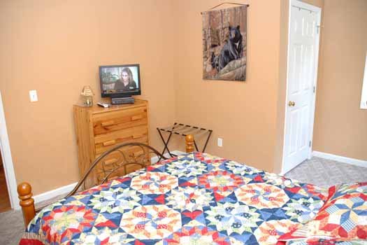 Bedroom with a TV and dresser at Heaven Sent, a 2-bedroom cabin rental located in Pigeon Forge